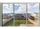 Backyard view from the window featuring a fenced yard and neighboring houses at 5957 N Orleans St, Aurora, CO 80019