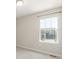 A bedroom with plush carpeting featuring a window with neighborhood views at 5957 N Orleans St, Aurora, CO 80019