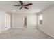 Bedroom with neutral walls, ceiling fan, plush carpet, and a window with a view at 5957 N Orleans St, Aurora, CO 80019