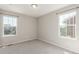A carpeted bedroom featuring large windows allowing for natural lighting and views at 5957 N Orleans St, Aurora, CO 80019