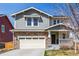 Charming two-story home with a stone facade and attached two-car garage in a suburban neighborhood at 5957 N Orleans St, Aurora, CO 80019