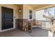 Inviting front porch featuring a wooden bench, decorative lanterns, and stone accents at 5957 N Orleans St, Aurora, CO 80019