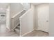 Hallway with stairs, light vinyl flooring, and access to other rooms at 5957 N Orleans St, Aurora, CO 80019