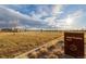 Sign for High Prairie Park with a view of the open space and walking paths at 5957 N Orleans St, Aurora, CO 80019