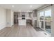 Modern kitchen featuring gray cabinets, stainless steel appliances, and a center island at 5957 N Orleans St, Aurora, CO 80019