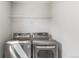 A laundry room featuring a front-loading washer and dryer, plus wire shelving at 5957 N Orleans St, Aurora, CO 80019