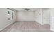Bright living room with light gray walls, vinyl floors, and abundant natural light at 5957 N Orleans St, Aurora, CO 80019