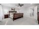 This spacious main bedroom features a ceiling fan, a queen bed, and bedside tables at 5957 N Orleans St, Aurora, CO 80019