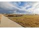 Path through High Prairie Park with an open grassy area and trees in the background at 5957 N Orleans St, Aurora, CO 80019