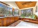Bright bathroom with wood cabinets, dual sinks, garden tub, and large windows with tree views at 994 Timber Ln, Boulder, CO 80304