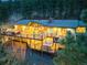 Aerial view of a home featuring a two-story deck with a hot tub and lush surrounding forest at 994 Timber Ln, Boulder, CO 80304