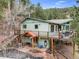 Inviting exterior featuring a large deck perfect for outdoor entertaining and stairs to the side yard at 994 Timber Ln, Boulder, CO 80304