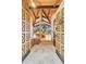Grand foyer featuring custom wood doors and stone floors leading to a sun-soaked living area with stunning views at 994 Timber Ln, Boulder, CO 80304