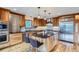 Updated kitchen with wood cabinets, stainless steel appliances, hardwood floors, and a center island with bar seating at 994 Timber Ln, Boulder, CO 80304