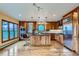 Open kitchen featuring a large island with bar stools, sleek stainless-steel appliances, and ample cabinet space at 994 Timber Ln, Boulder, CO 80304
