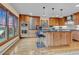Bright kitchen has light wood cabinets, stainless steel appliances, stone counters and breakfast bar at 994 Timber Ln, Boulder, CO 80304