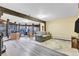 Bright living room with hardwood floors, wood beams, and expansive windows offering views of the surrounding nature at 994 Timber Ln, Boulder, CO 80304