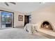 Bright main bedroom featuring carpeted floors, fireplace, and balcony access with sunset views at 994 Timber Ln, Boulder, CO 80304