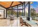 Bright sun room with floor-to-ceiling windows showcasing stunning views and access to the outdoor deck at 994 Timber Ln, Boulder, CO 80304