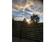 Deck view of scenic sunset over pine trees and distant mountains at 994 Timber Ln, Boulder, CO 80304