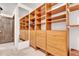 Walk-in closet featuring custom wooden shelving, ample storage space, and carpeted floors at 994 Timber Ln, Boulder, CO 80304