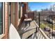 Cozy balcony with wrought iron railing and a small bistro set at 418 Steele St, Denver, CO 80206