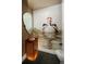 Unique powder room featuring a textured wall, modern vanity, and a statement mirror with artistic wall decor at 418 Steele St, Denver, CO 80206