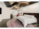 Luxurious bedroom featuring a custom headboard, hardwood floors, modern lighting, and a comfortable sitting area at 418 Steele St, Denver, CO 80206