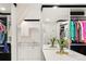 Custom closet and dressing area with a built-in vanity, ample storage, mirrored wall, and luxurious finishes at 418 Steele St, Denver, CO 80206