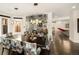 Bright dining room with wine storage, modern pendant lights, and a table with decorative chairs, open to the kitchen at 418 Steele St, Denver, CO 80206