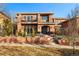 Two-story brick home with decorative shrubs and brick wall, and balcony area at 418 Steele St, Denver, CO 80206