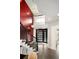 Grand foyer showcases a striking red accent wall, iron staircase railing, and contemporary lighting fixtures at 418 Steele St, Denver, CO 80206