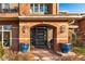 Brick home featuring a gated entryway with potted plants adding color and curb appeal at 418 Steele St, Denver, CO 80206