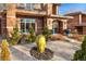 Beautifully landscaped front yard with mature shrubbery and a unique oversized decorative urn feature at 418 Steele St, Denver, CO 80206