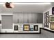 Garage cabinets offer great storage above the speckled epoxy flooring, with gallery wall decorations at 418 Steele St, Denver, CO 80206
