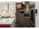 Chef's kitchen with high-end stainless steel appliances, custom cabinets, and a coffee machine at 418 Steele St, Denver, CO 80206