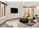 Cozy living room with hardwood floors, a comfortable sectional, contemporary furnishings, and outdoor patio access at 418 Steele St, Denver, CO 80206
