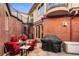 Charming brick patio featuring a fire pit, grill, and spiral staircase at 418 Steele St, Denver, CO 80206