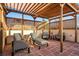 Covered patio features lounge chairs on a red brick surface at 418 Steele St, Denver, CO 80206