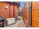 Narrow side yard with brick pavers and a modern fence at 418 Steele St, Denver, CO 80206