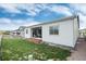 Well-maintained backyard featuring a small deck, white siding, and a lush lawn at 5072 Silver Hare Ln, Castle Rock, CO 80104