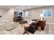 The finished basement provides a relaxing atmosphere with a TV, comfortable seating, and natural light at 5072 Silver Hare Ln, Castle Rock, CO 80104
