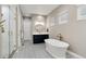 Bright bathroom featuring a soaking tub, stylish vanity, and a glass-enclosed shower at 5072 Silver Hare Ln, Castle Rock, CO 80104