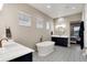 Luxurious bathroom with a soaking tub, dual vanities, and elegant tile flooring at 5072 Silver Hare Ln, Castle Rock, CO 80104