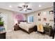 Comfortable bedroom featuring a cozy bed, desk, ceiling fan, and ample natural light at 5072 Silver Hare Ln, Castle Rock, CO 80104