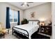 Cozy bedroom featuring a black iron bed, a bright window, and colorful decor at 5072 Silver Hare Ln, Castle Rock, CO 80104