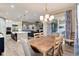 Bright dining room with a wooden table, chairs, chandelier, and access to the patio at 5072 Silver Hare Ln, Castle Rock, CO 80104