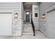 Inviting front entrance with a decorated door, exterior sconces, and well-manicured stone accents at 5072 Silver Hare Ln, Castle Rock, CO 80104