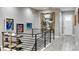 Upstairs hallway with black metal railings, stylish flooring, and decorative paintings adding charm at 5072 Silver Hare Ln, Castle Rock, CO 80104
