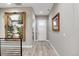 Hallway featuring neutral paint, light wood floors and decorative artwork which enhances the aesthetic appeal at 5072 Silver Hare Ln, Castle Rock, CO 80104